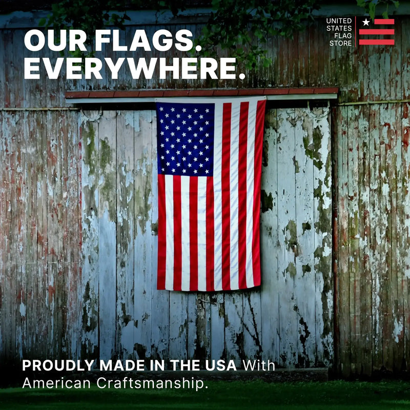 American flag hanging on a weathered wooden fence with branding text.