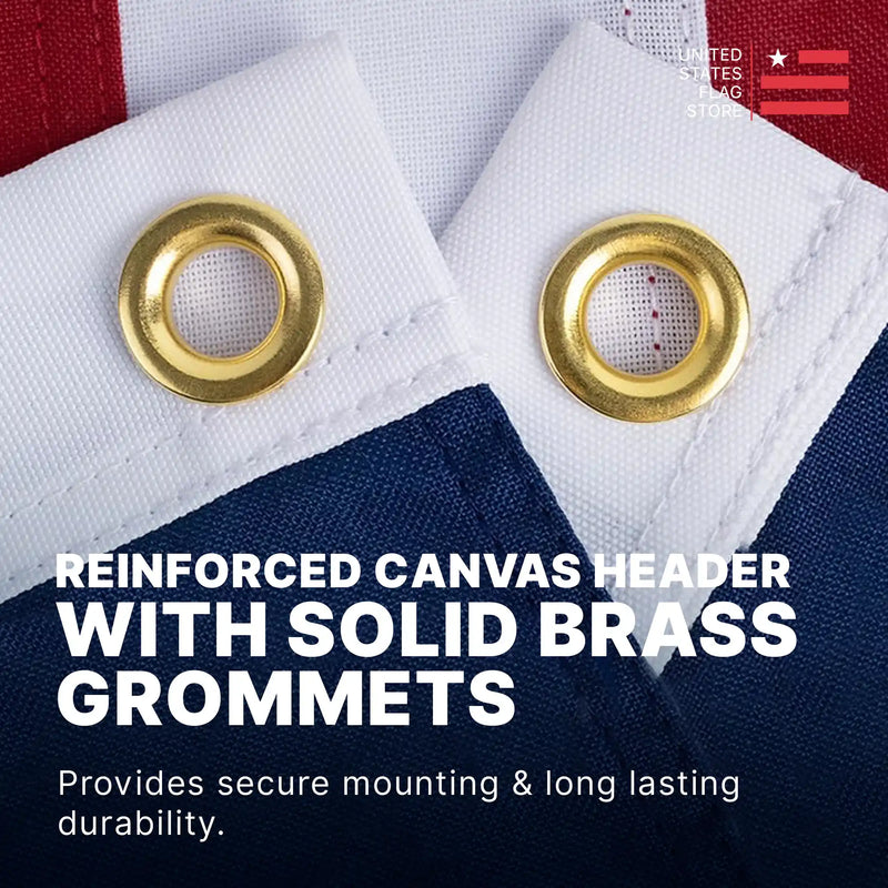 Close-up of a reinforced white canvas header with two solid brass grommets for secure mounting.